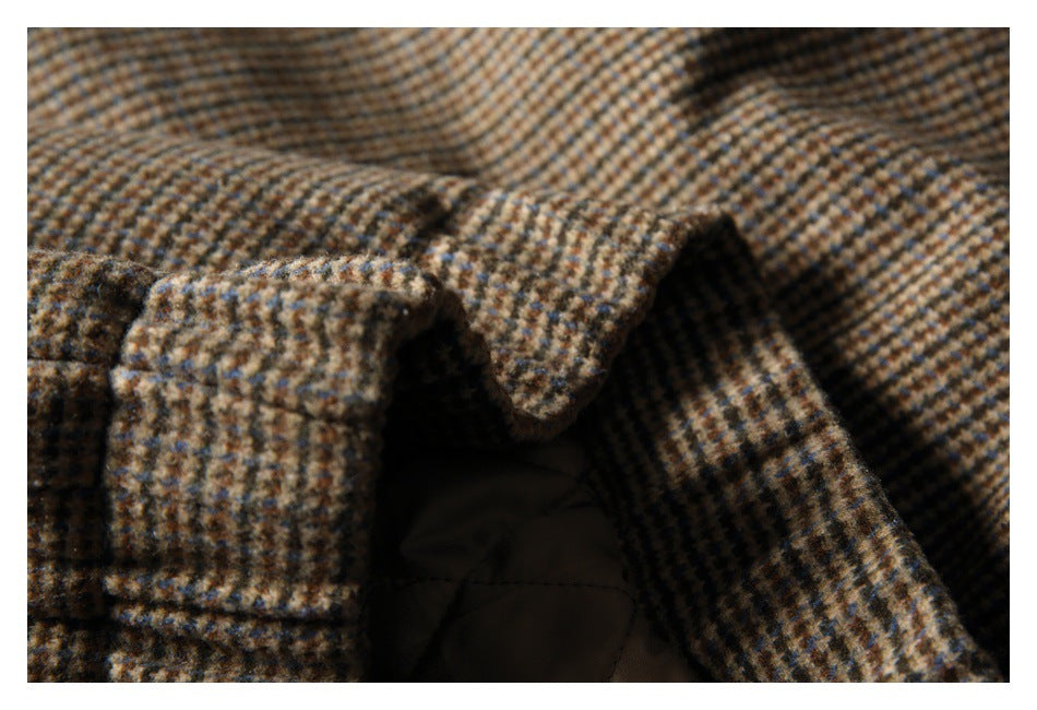 Close-up of checked garment fabric beside a dark opening and lining.