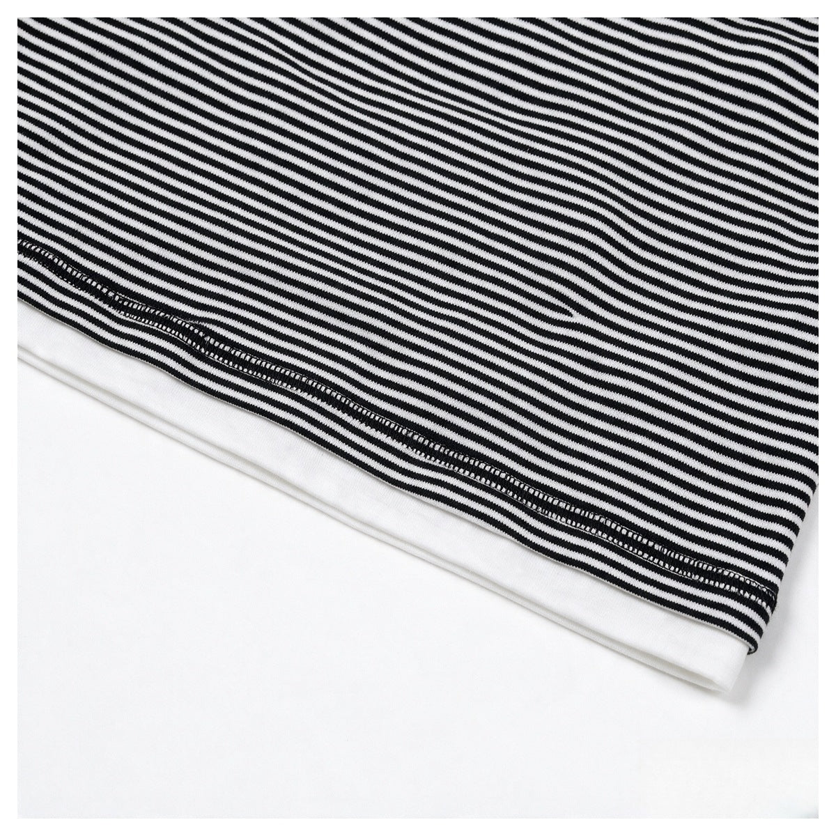 Close-up of a black-and-white finely striped garment hem with visible stitching.