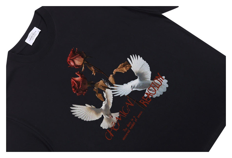 Black crew-neck T-shirt laid flat, printed with two white doves, roses and red English lettering.