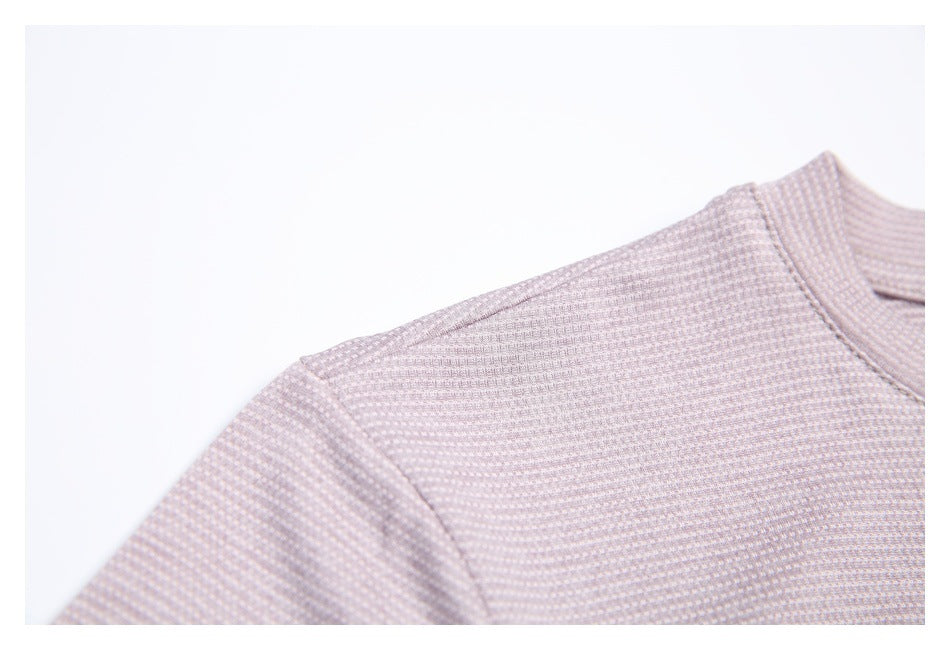 Close-up of the pale mauve shirt's shoulder seam, sleeve, and fine repeating pattern.