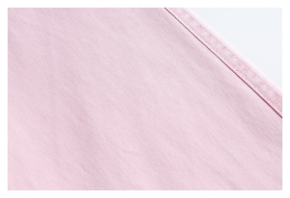 Close-up of pale pink jacket fabric with a curved stitched seam.
