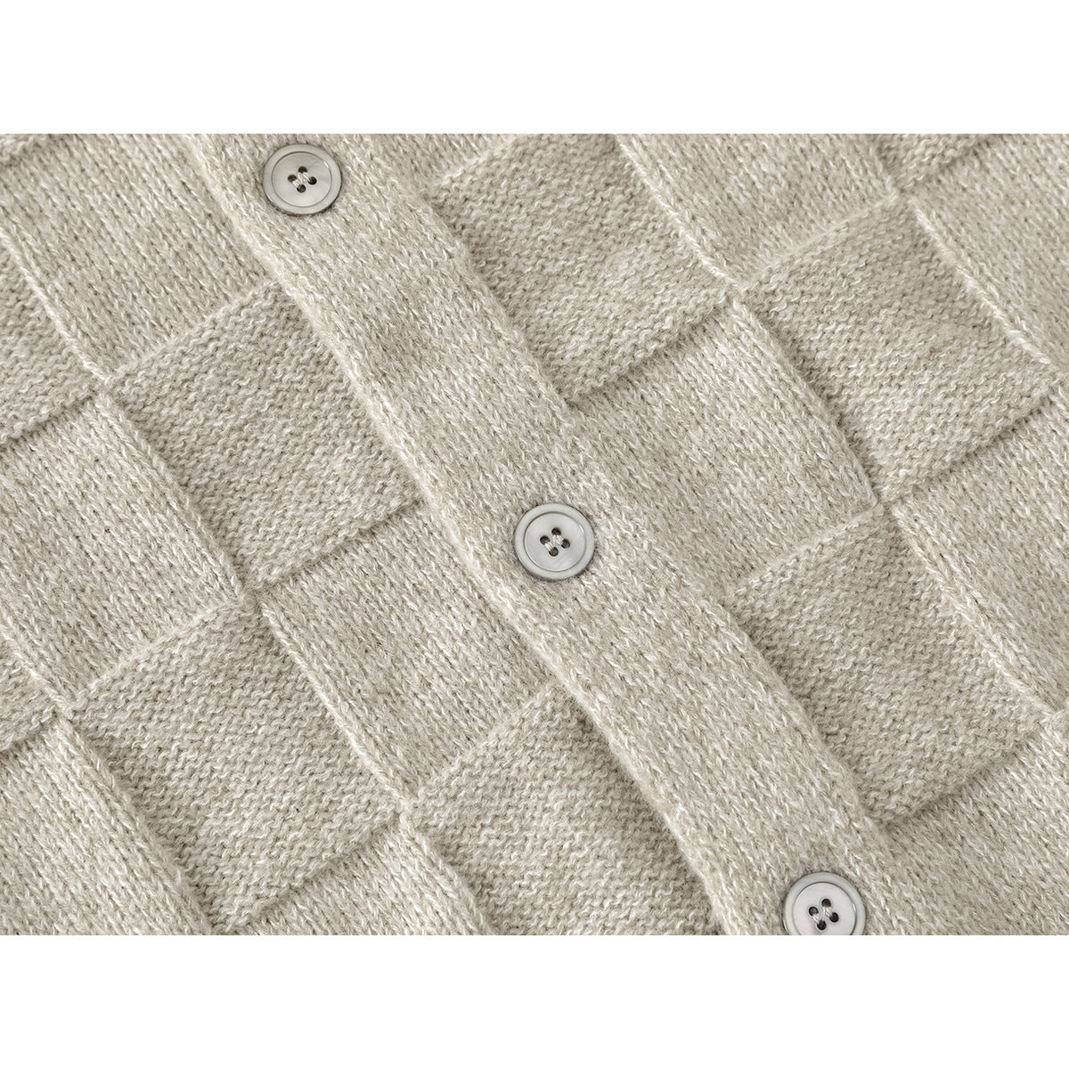 Close-up of the light beige cardigan's textured knit and three-button front placket.
