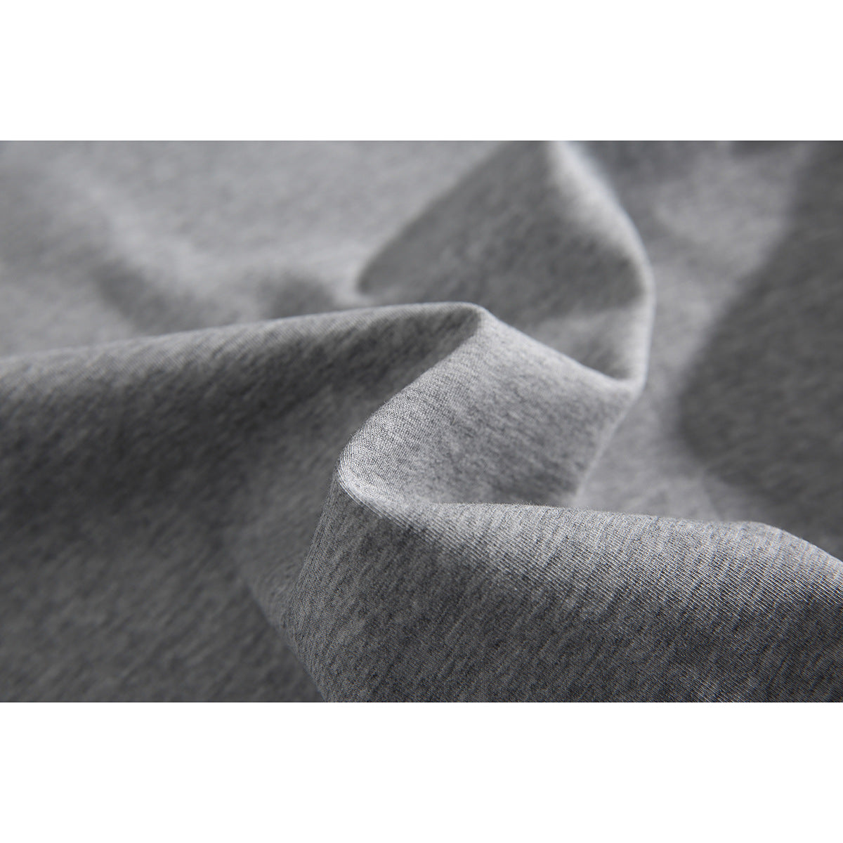 Macro view of heather gray fabric draped to show its surface and texture.