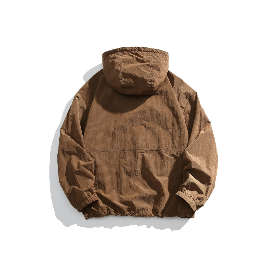 Back view of a brown hooded jacket with long sleeves, elastic cuffs, and a gathered hem, laid flat on white.
