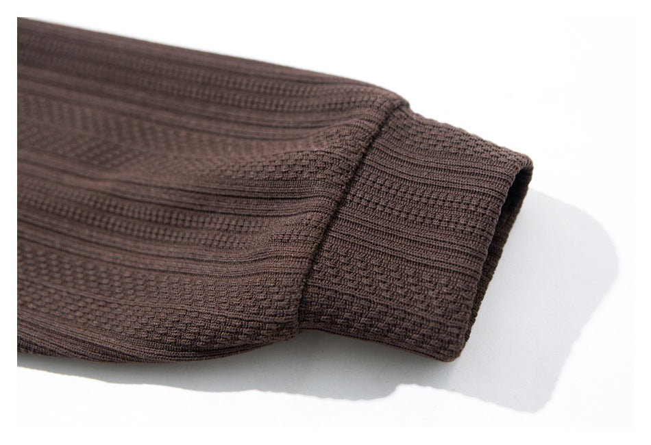 Close-up of the dark brown textured shirt sleeve ending in a wide cuff.