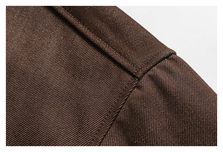 Close-up of a brown shirt shoulder seam and topstitching.