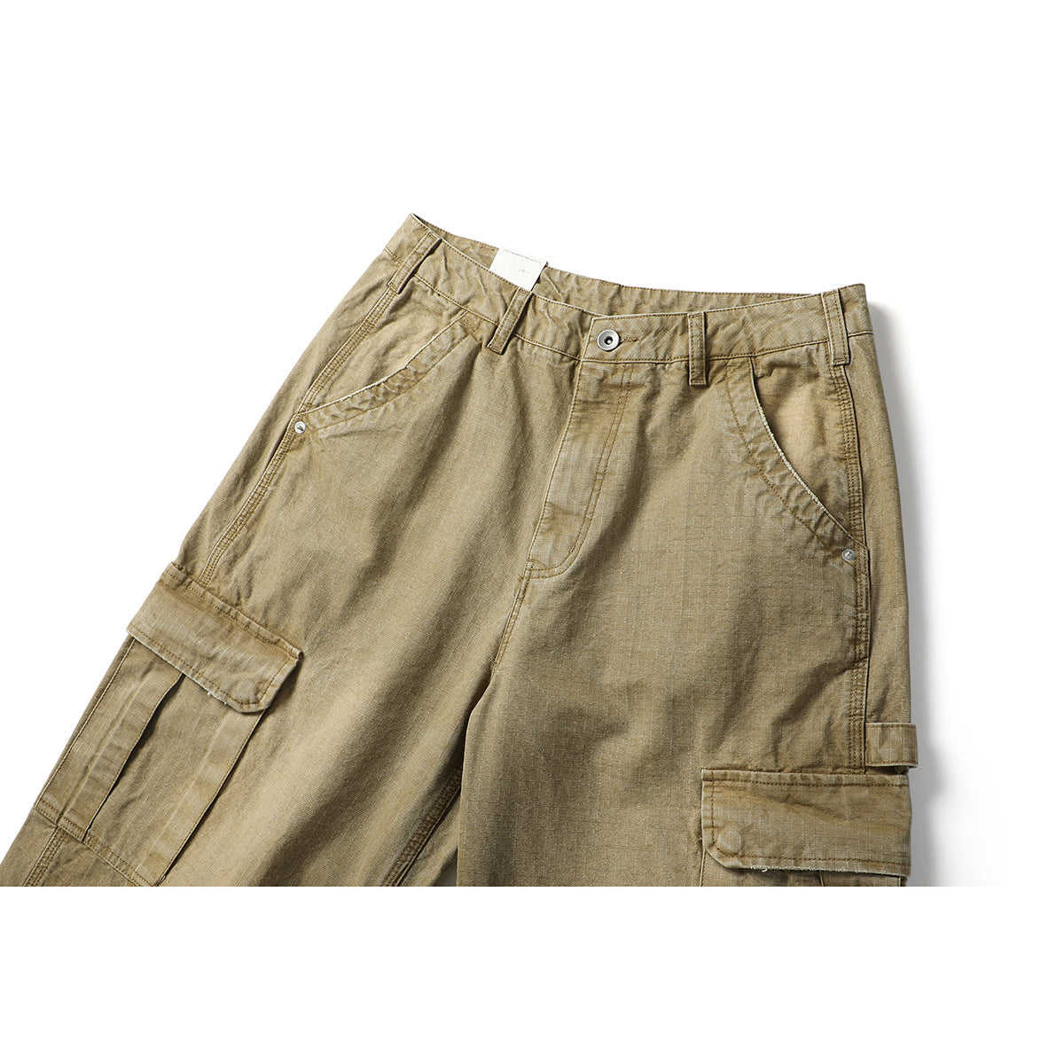 Close-up front view of khaki cargo pants showing the waistband, button, angled pockets and flap cargo pockets.