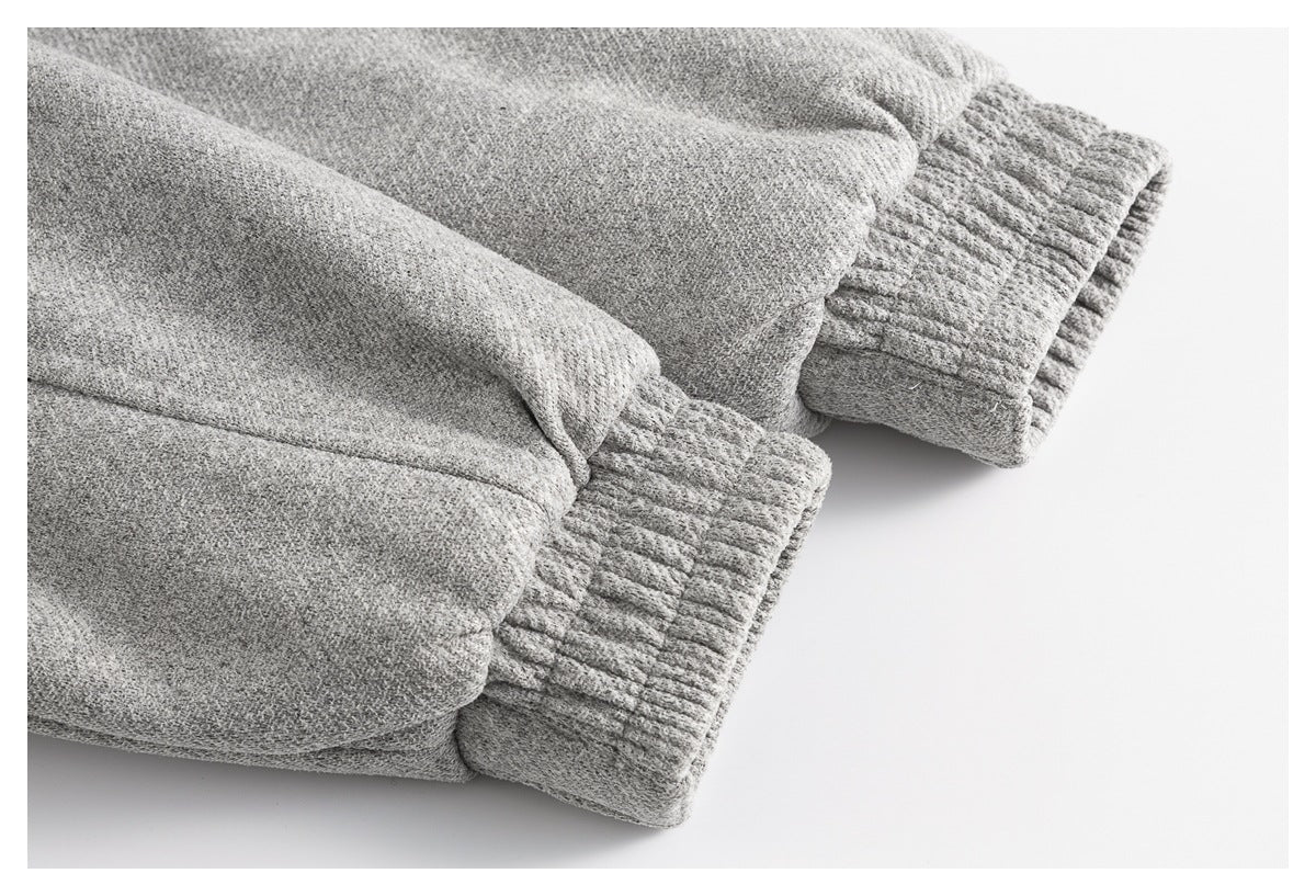 Close-up of gray garment sleeves ending in wide ribbed cuffs.