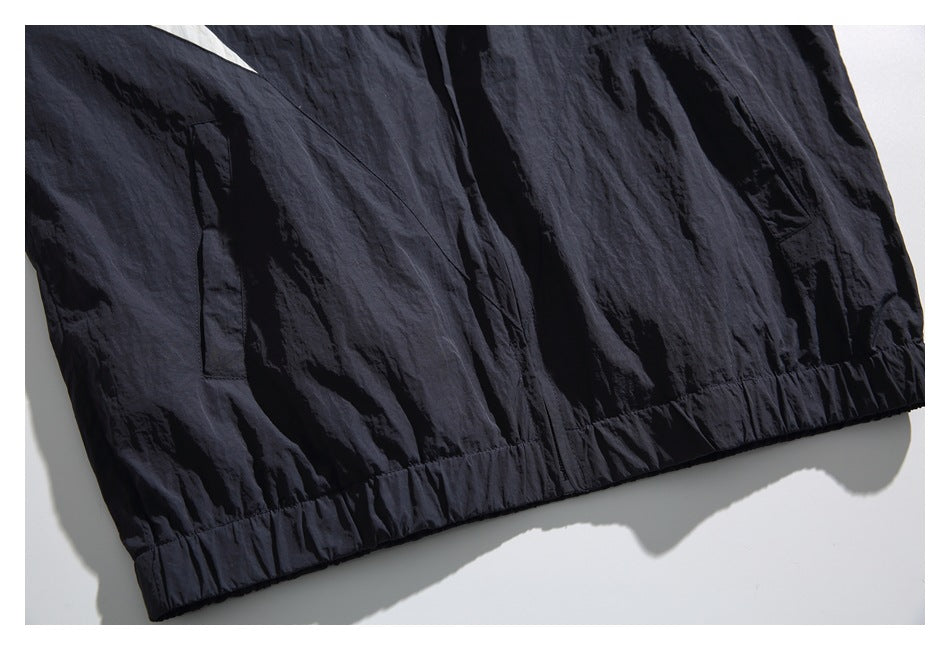 Close-up of a dark navy garment showing a vertical pocket and gathered hem.