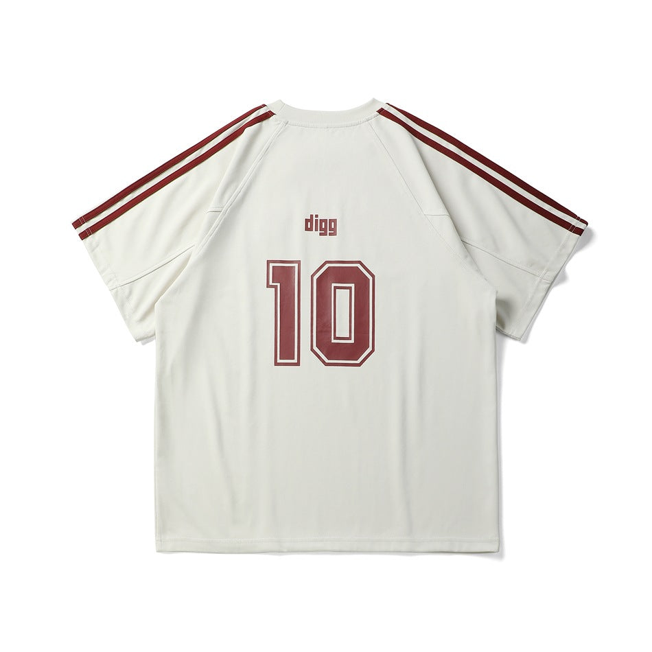Back view of a cream short-sleeve shirt with burgundy shoulder stripes, “digg” lettering and a large outlined number 10.