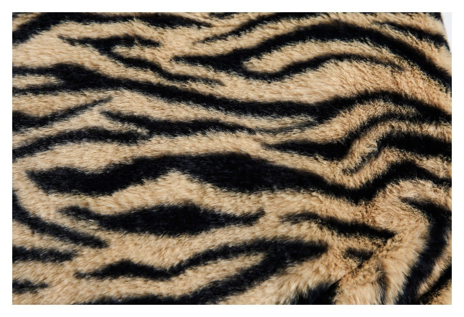 Close-up texture of tan-and-black tiger-striped faux fur.