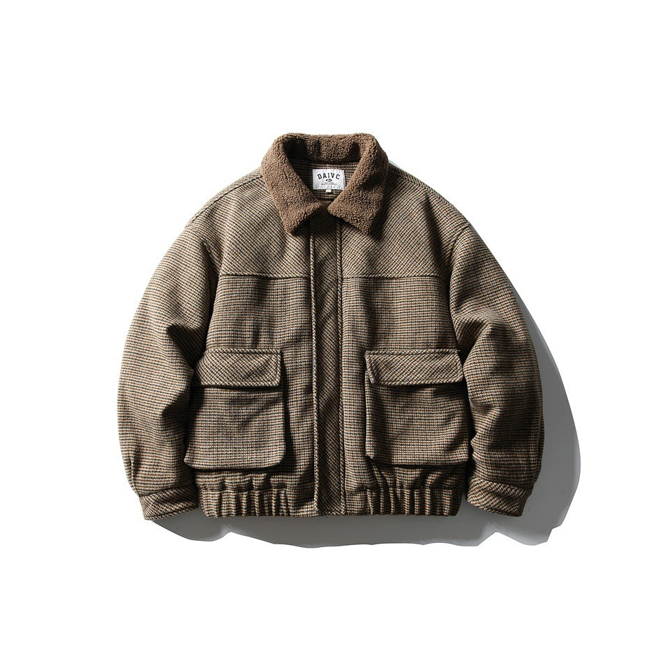 Brown houndstooth bomber-style jacket with fleece-like collar, two large flap pockets and elastic hem, front view