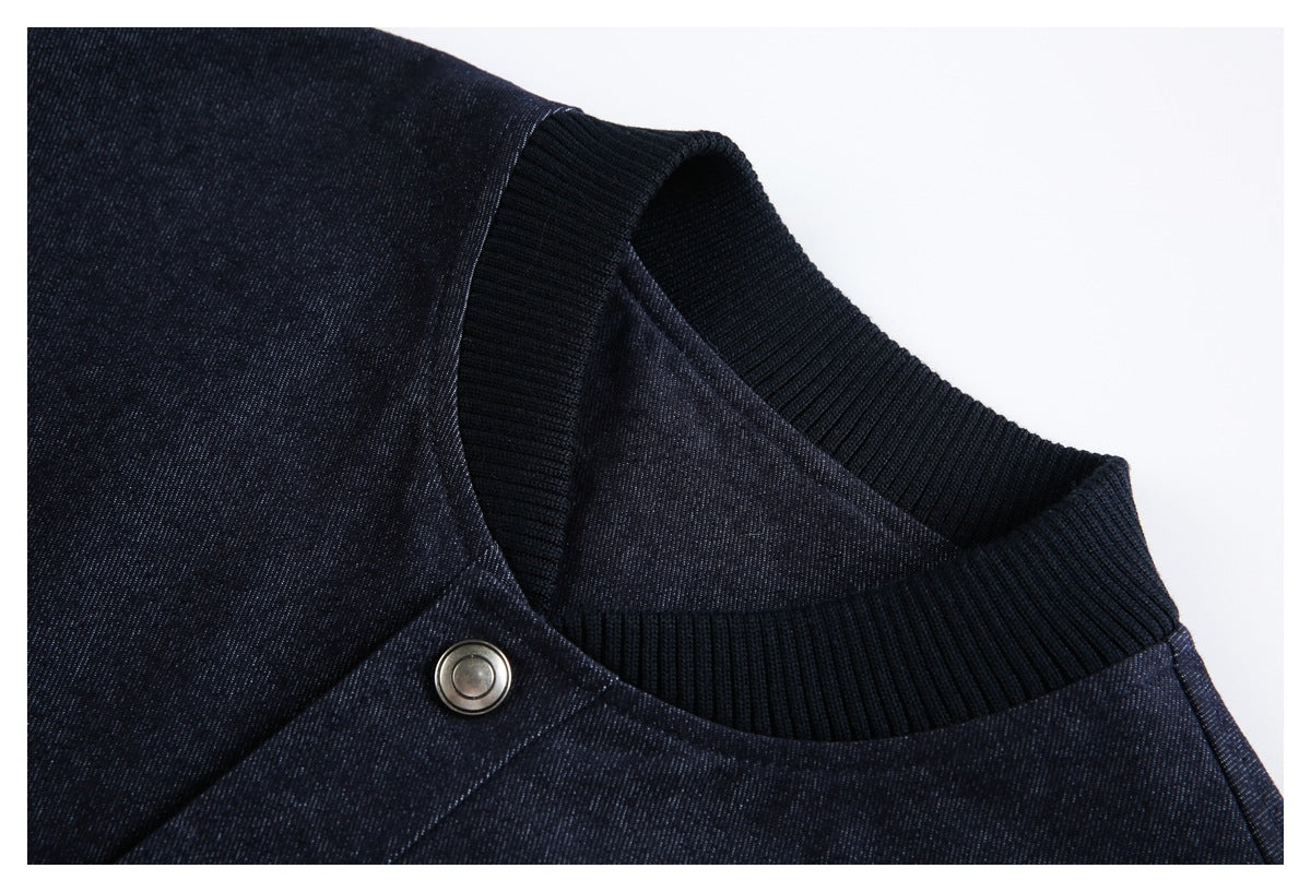 Close-up of the dark navy jacket's black ribbed collar and a metal snap fastener.