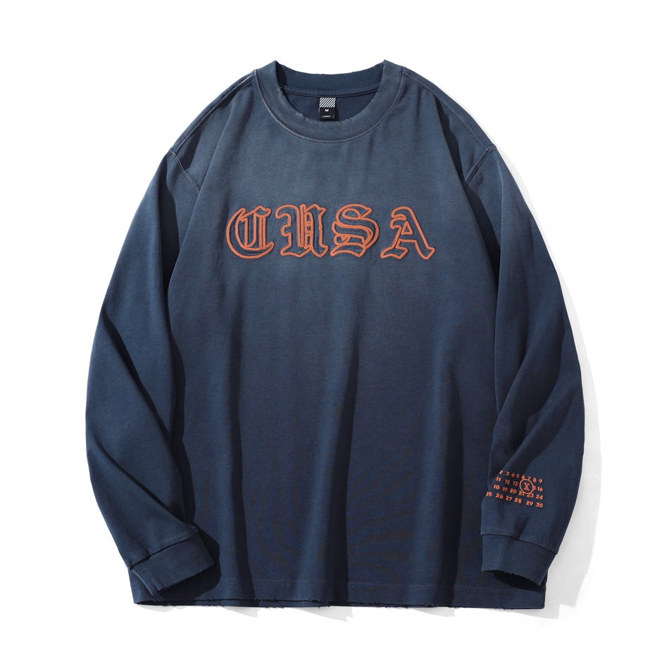 Blue faded long-sleeve crewneck top with orange blackletter CUSA embroidery on the chest, flat front view