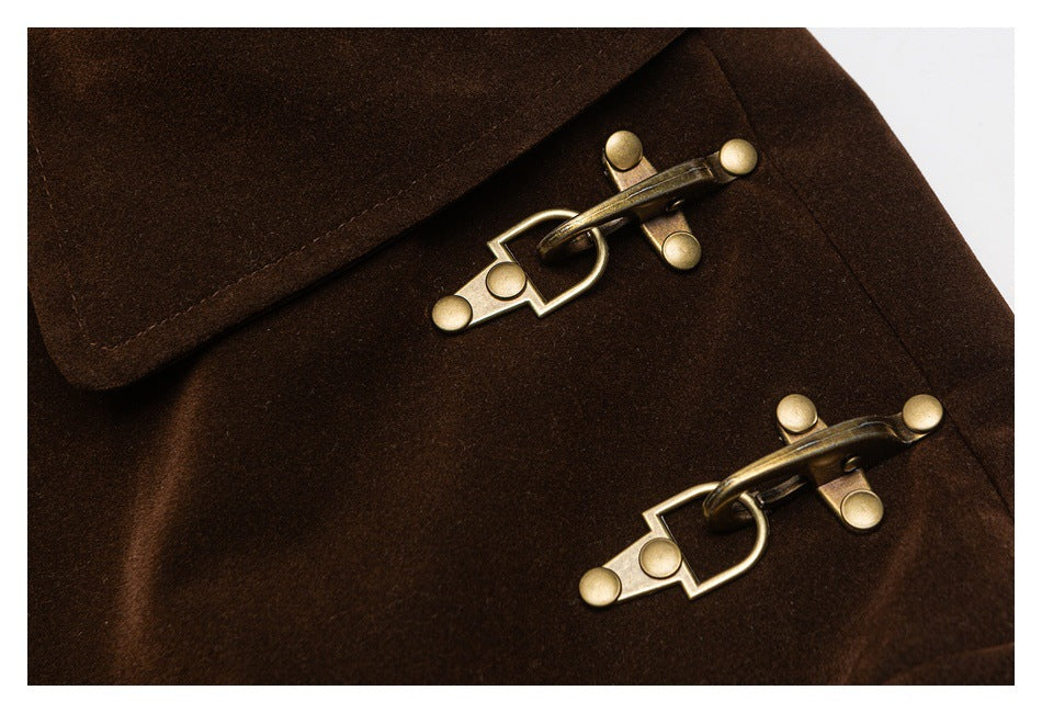 Close-up of two antique-brass clasp fasteners on dark brown fabric.