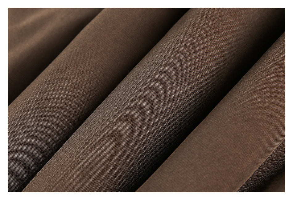Extreme close-up of smooth brown garment fabric arranged in soft folds.