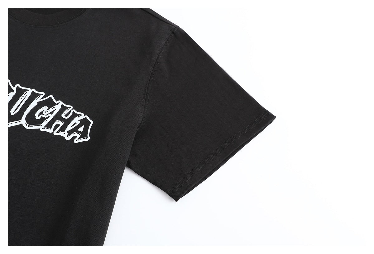 Close-up of the black T-shirt's short sleeve, shoulder seam, and partial white chest graphic.
