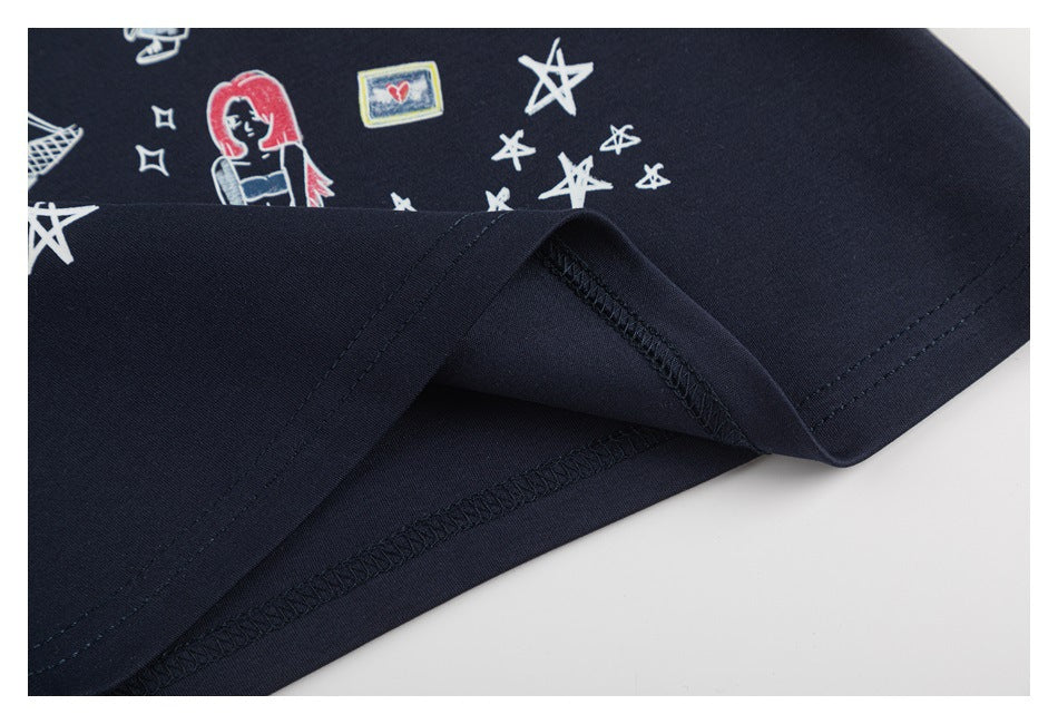 Close-up of a navy garment hem showing stitching and a colorful illustration with star motifs.