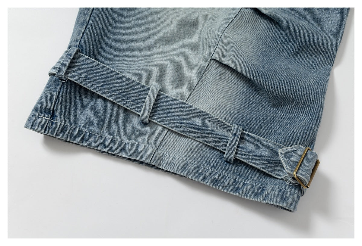 Blue denim hem detail with an adjustable matching strap, belt loops, and a small metal buckle.