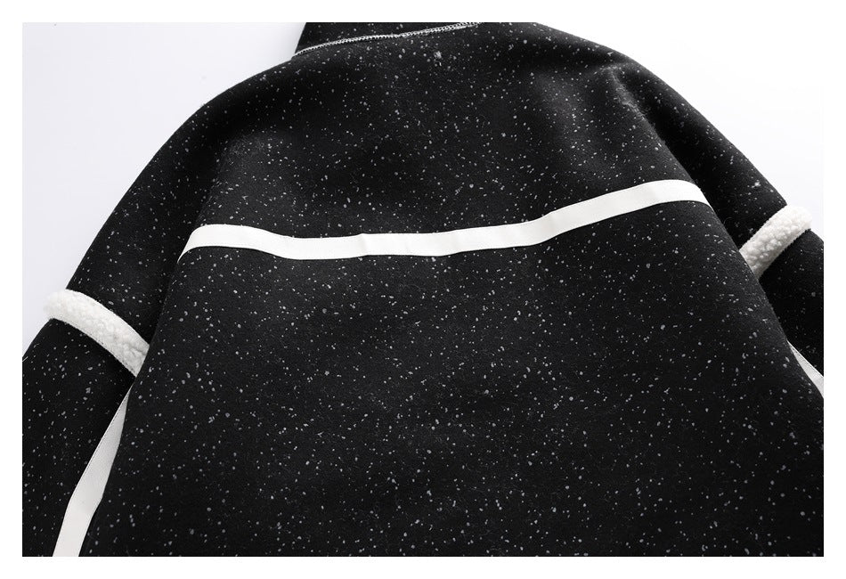 Cropped back view of a black speckled jacket with a white horizontal stripe and fleece-trimmed sleeves.