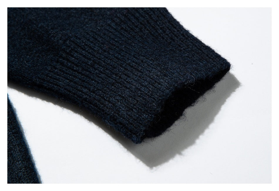 Close-up of the dark navy sweater’s ribbed sleeve cuff.