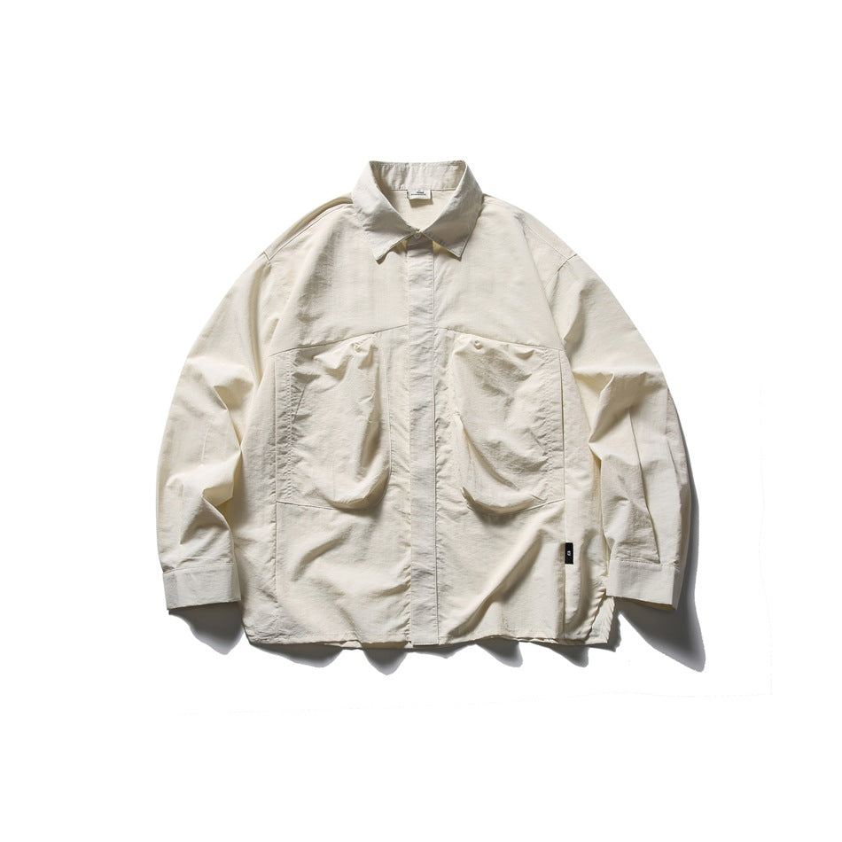 Off-white long-sleeve shirt flat lay with pointed collar, concealed placket and two large pleated chest pockets