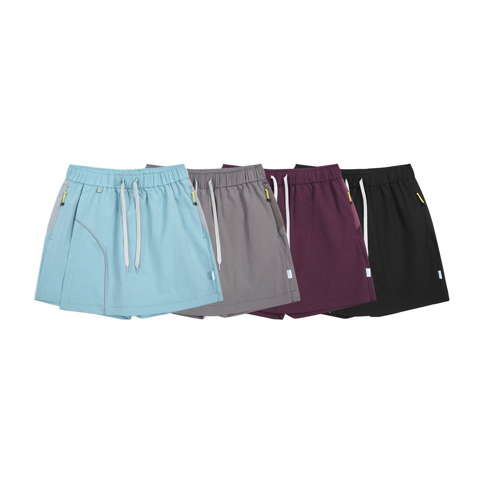 Four athletic skorts displayed together in light blue, gray, plum, and black.