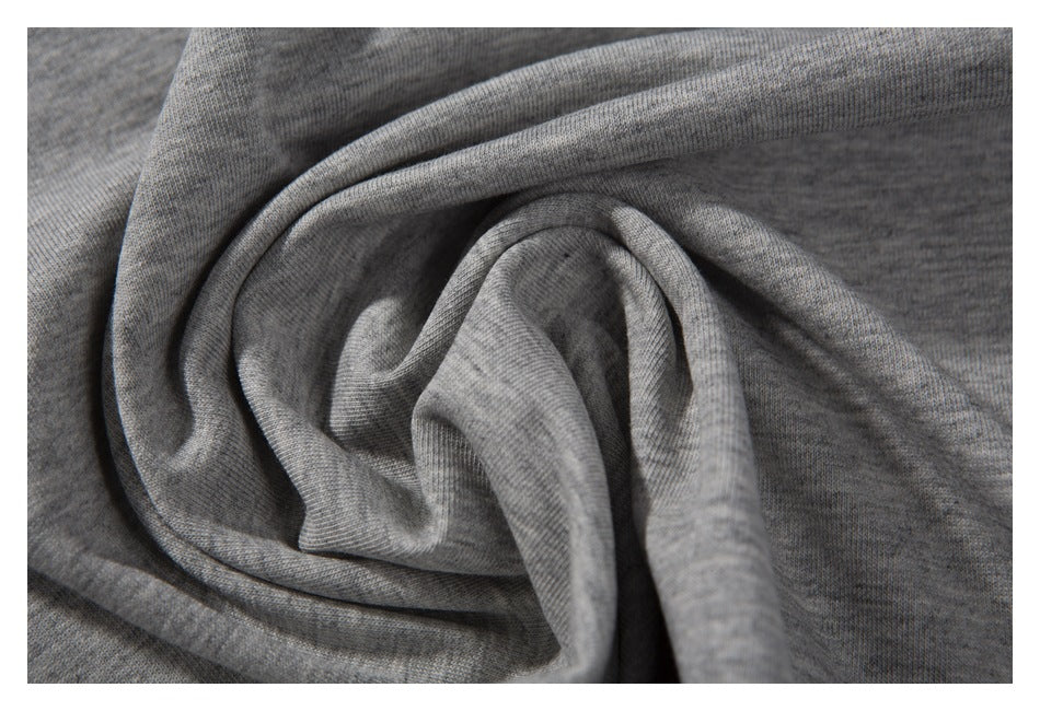 Close-up of heather-gray knit fabric gathered into soft folds.