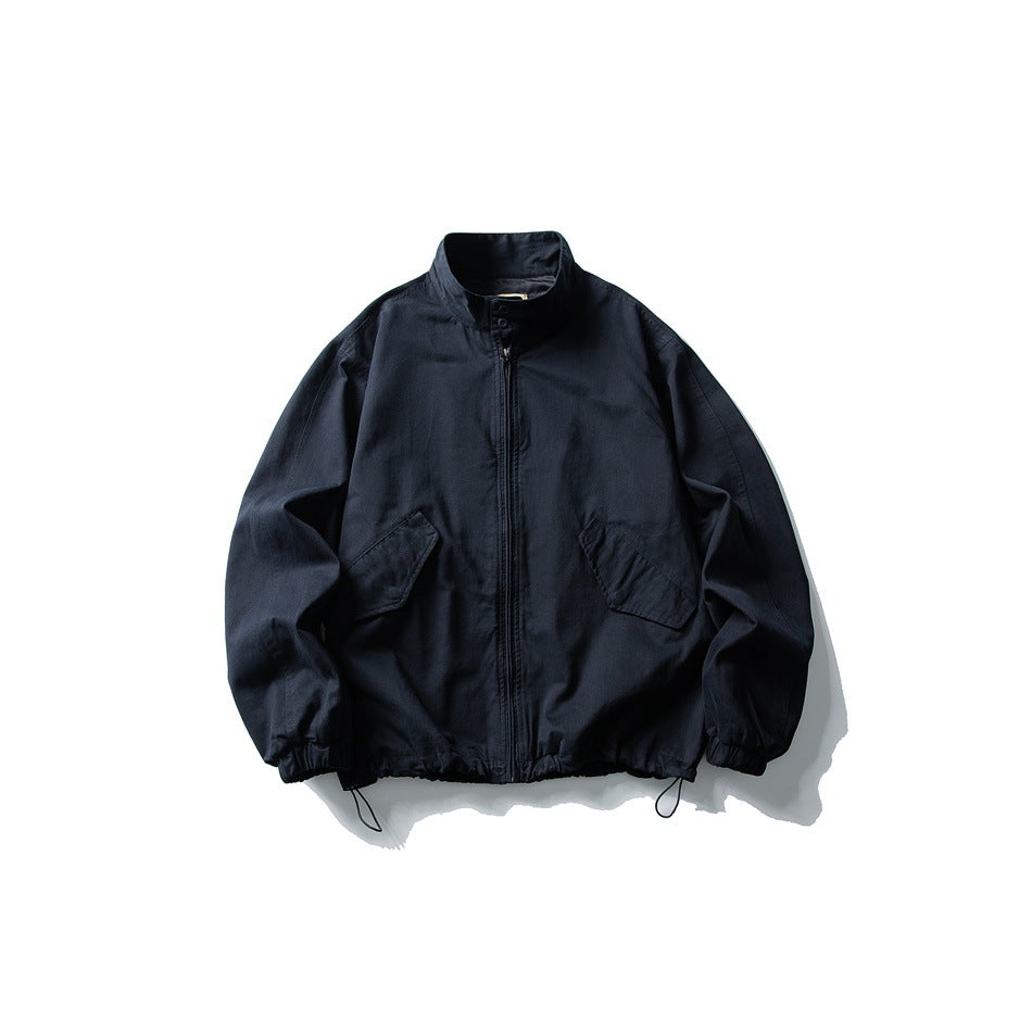 Navy stand-collar zip jacket flat lay with flap pockets, elastic cuffs and drawcord hem