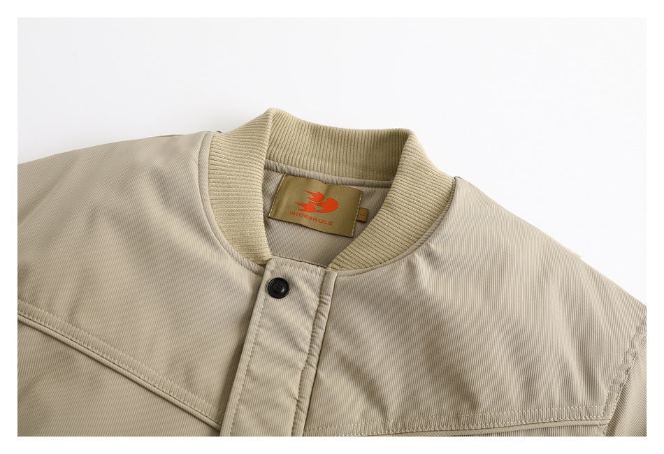 Close-up of the beige jacket's ribbed collar, button placket, stitched yoke, and neck label.