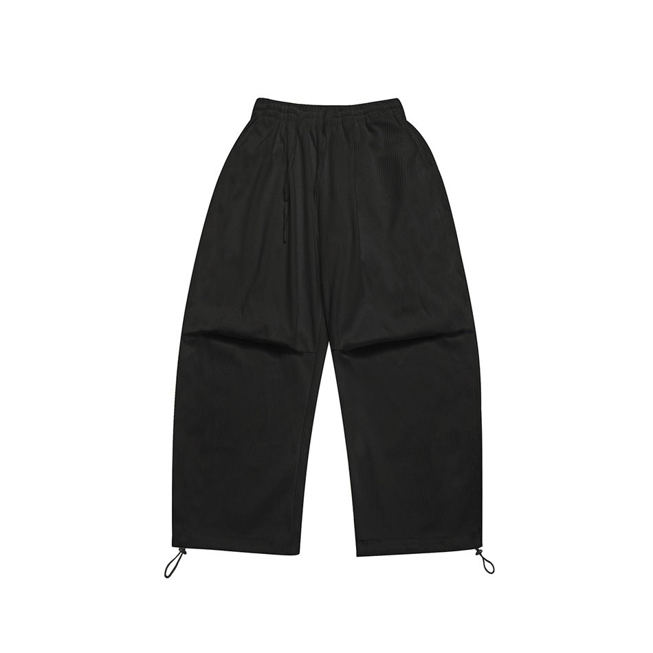 Black ribbed wide-leg pants flat lay with elastic drawstring waist and toggle cord hems