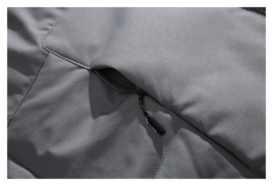 Close-up of a dark gray jacket with a concealed zipper and black cord pull.