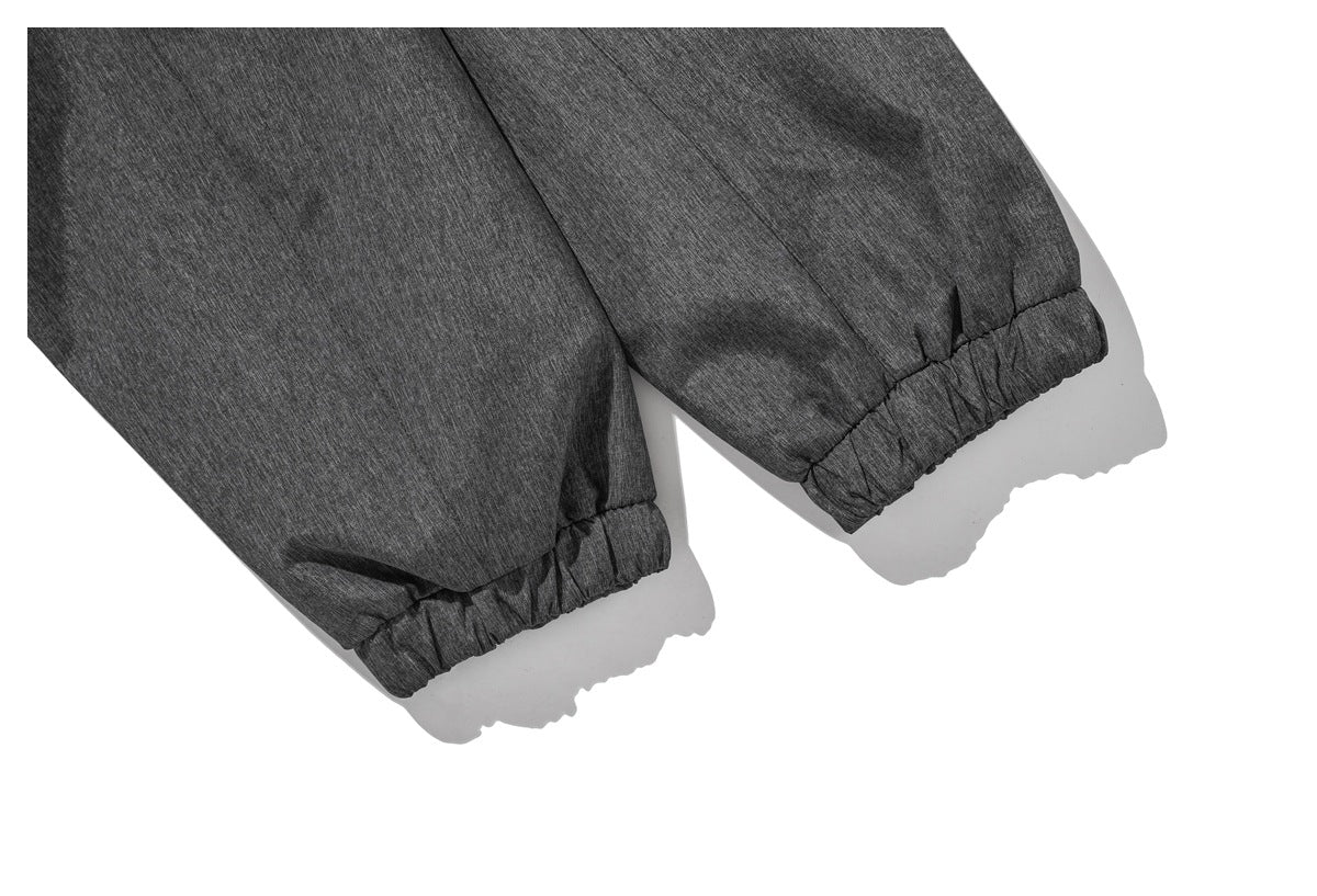Close-up of two charcoal heather jacket sleeves with gathered elastic cuffs.