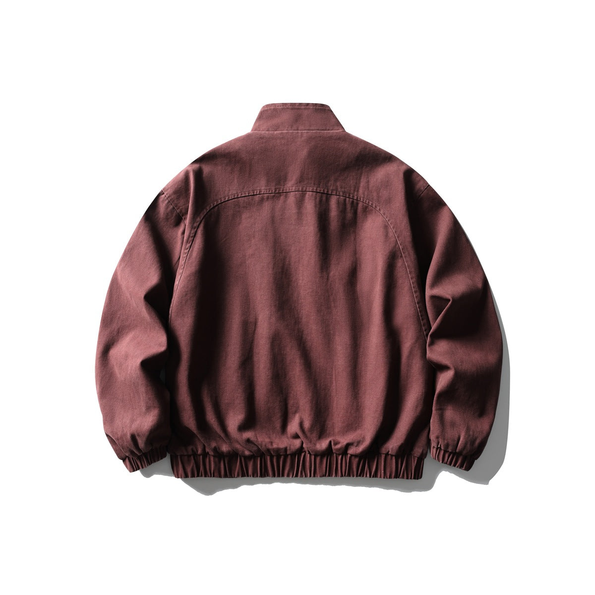 Back view of a burgundy jacket with a stand collar and gathered elastic hem and cuffs.