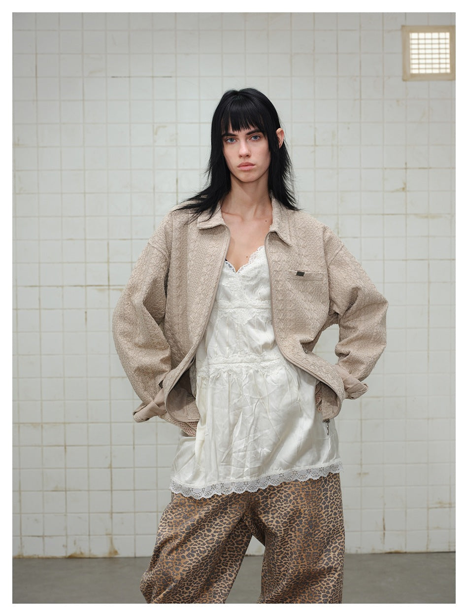 Model with hands on hips wearing the open khaki textured jacket over a white lace camisole