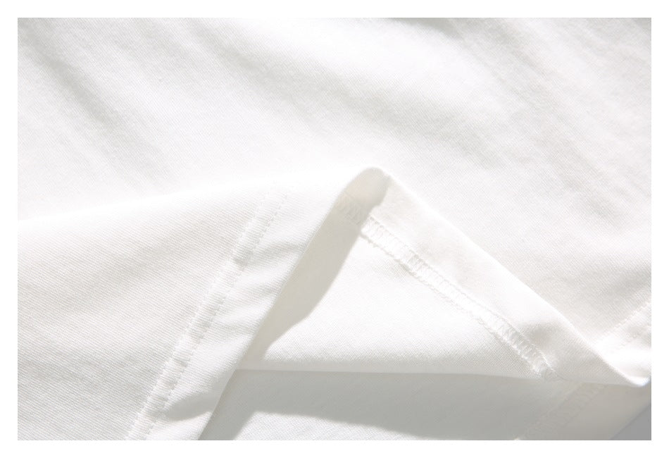 Close-up of white fabric folded to show a stitched seam.