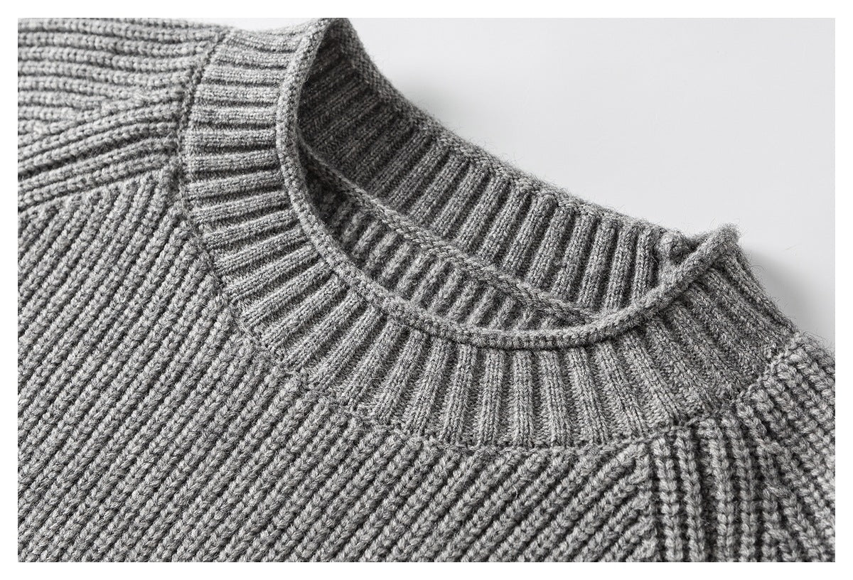 Close-up of a gray sweater's ribbed crewneck collar and textured knit.