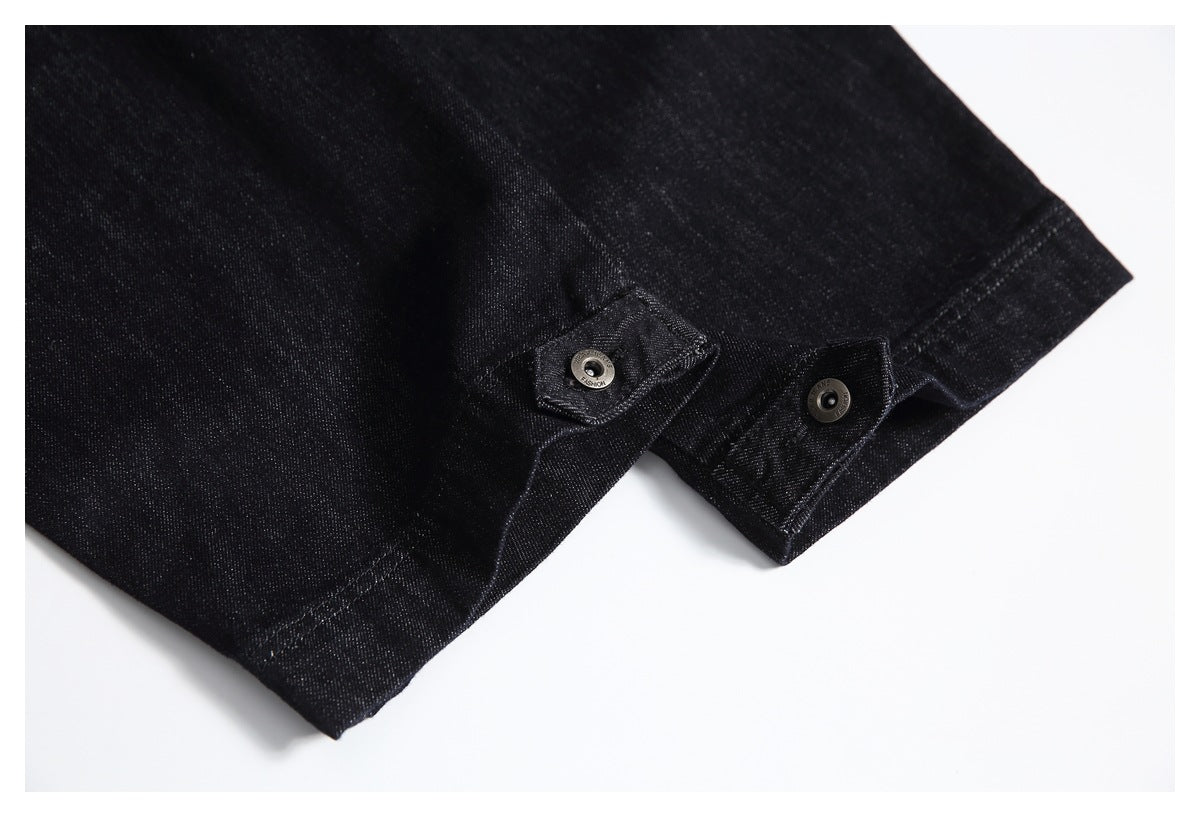 Black jeans hem with adjustable snap-tab details, shown from an angle.