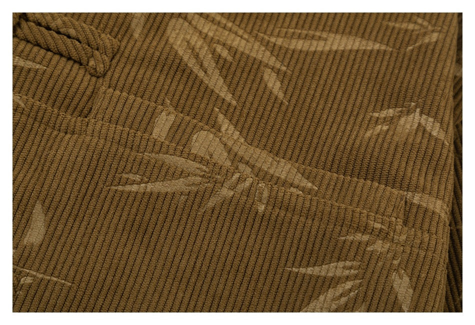 Close-up showing the brown jacket's ribbed texture and lighter bamboo-leaf pattern.