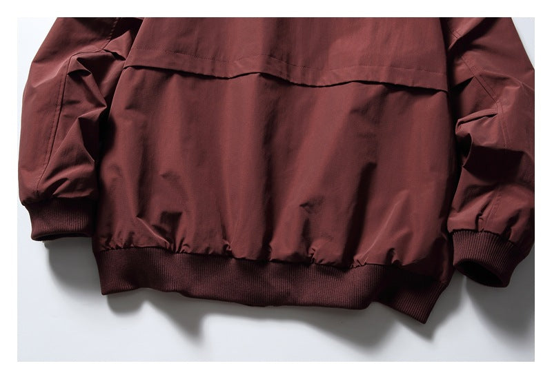 Lower back of a burgundy jacket showing the back panel, sleeves, ribbed cuffs, and ribbed hem.