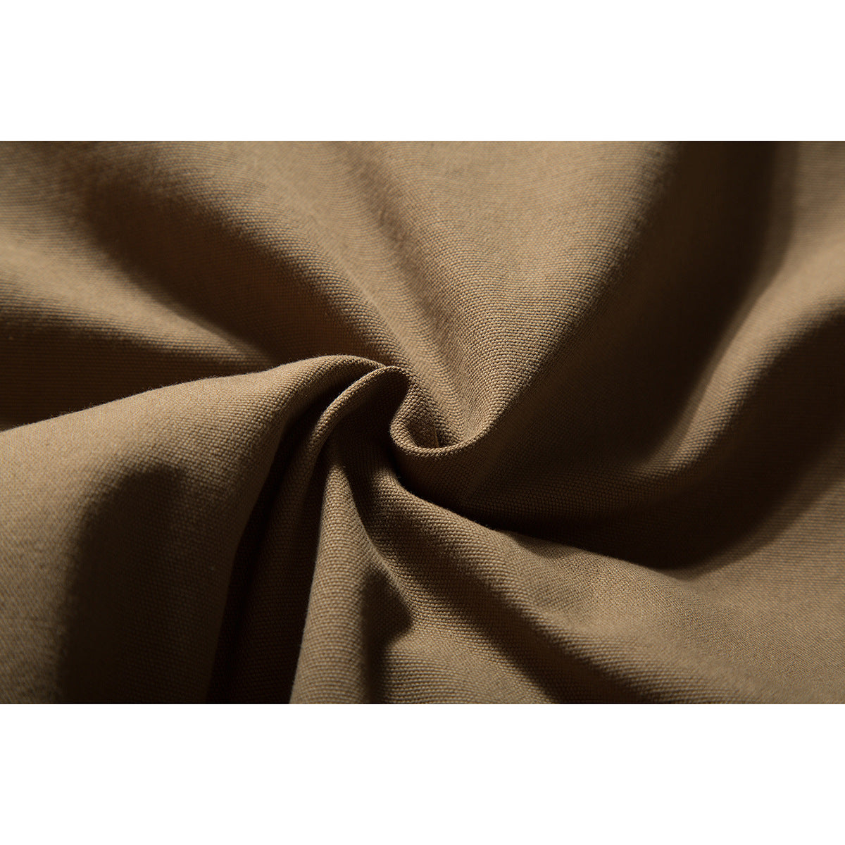 Macro view of textured brown jacket fabric gathered into folds.
