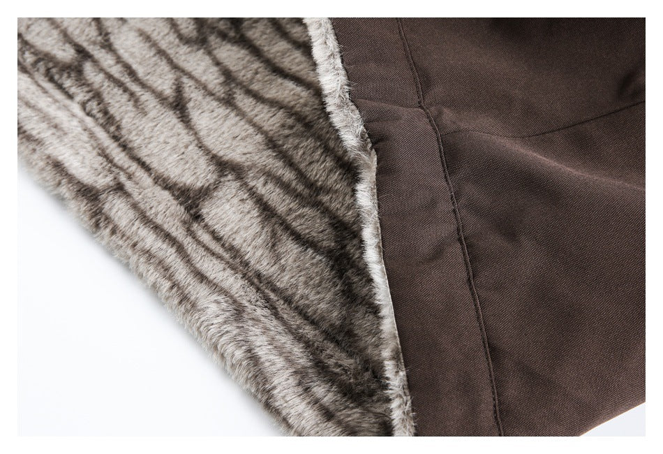 Close-up of a brown garment showing gray-brown faux-fur lining beside the smooth outer fabric.