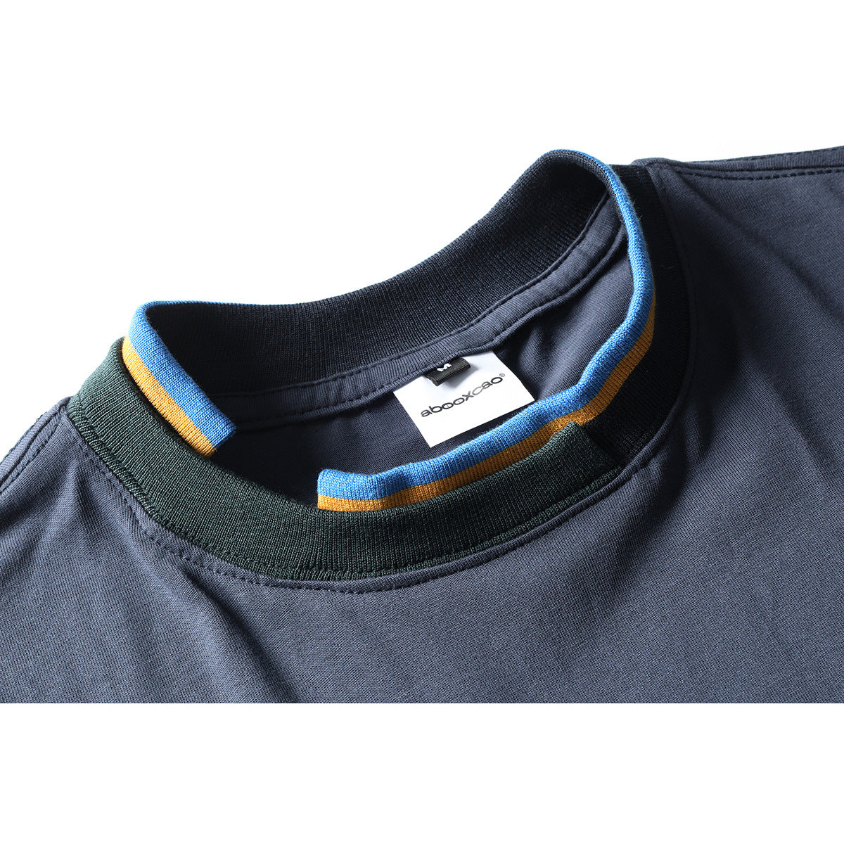 Close-up of a slate-blue shirt neckline with dark ribbing and blue and ochre striped trim.