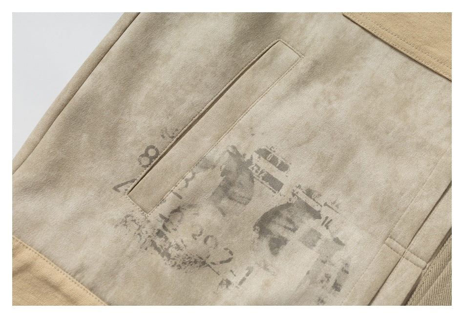 Close-up of a beige garment panel with a narrow welt pocket and a faded gray graphic.