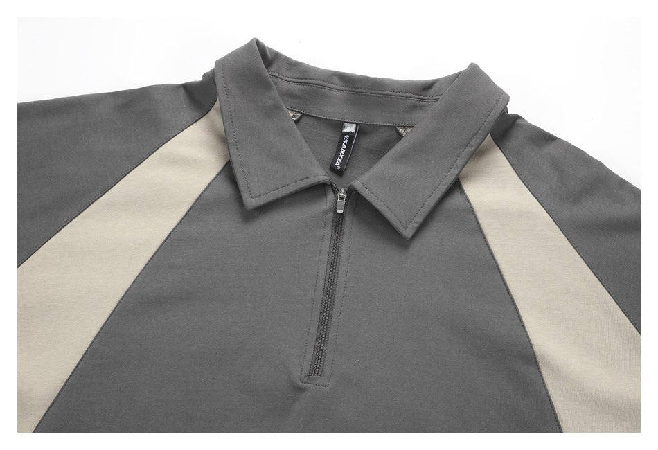 Close-up of a charcoal shirt's pointed collar, short zipper, and beige contrast panels.