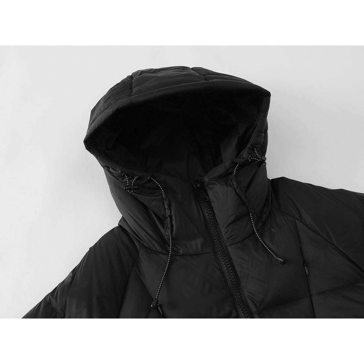 Close-up of a black puffer jacket's hood, drawcords, and front zipper.