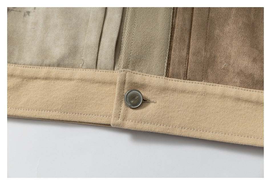 Close-up of a tan waistband with a dark button and several brown garment panels behind it.
