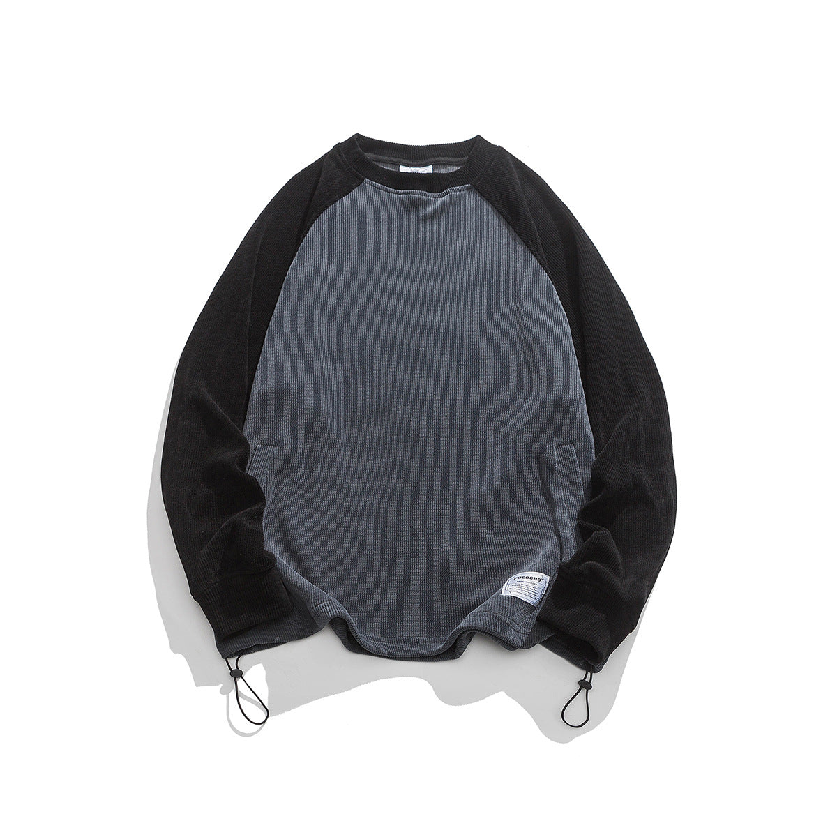 Gray ribbed crewneck sweatshirt with black raglan sleeves, hem drawcord toggles and a small woven label, flat lay