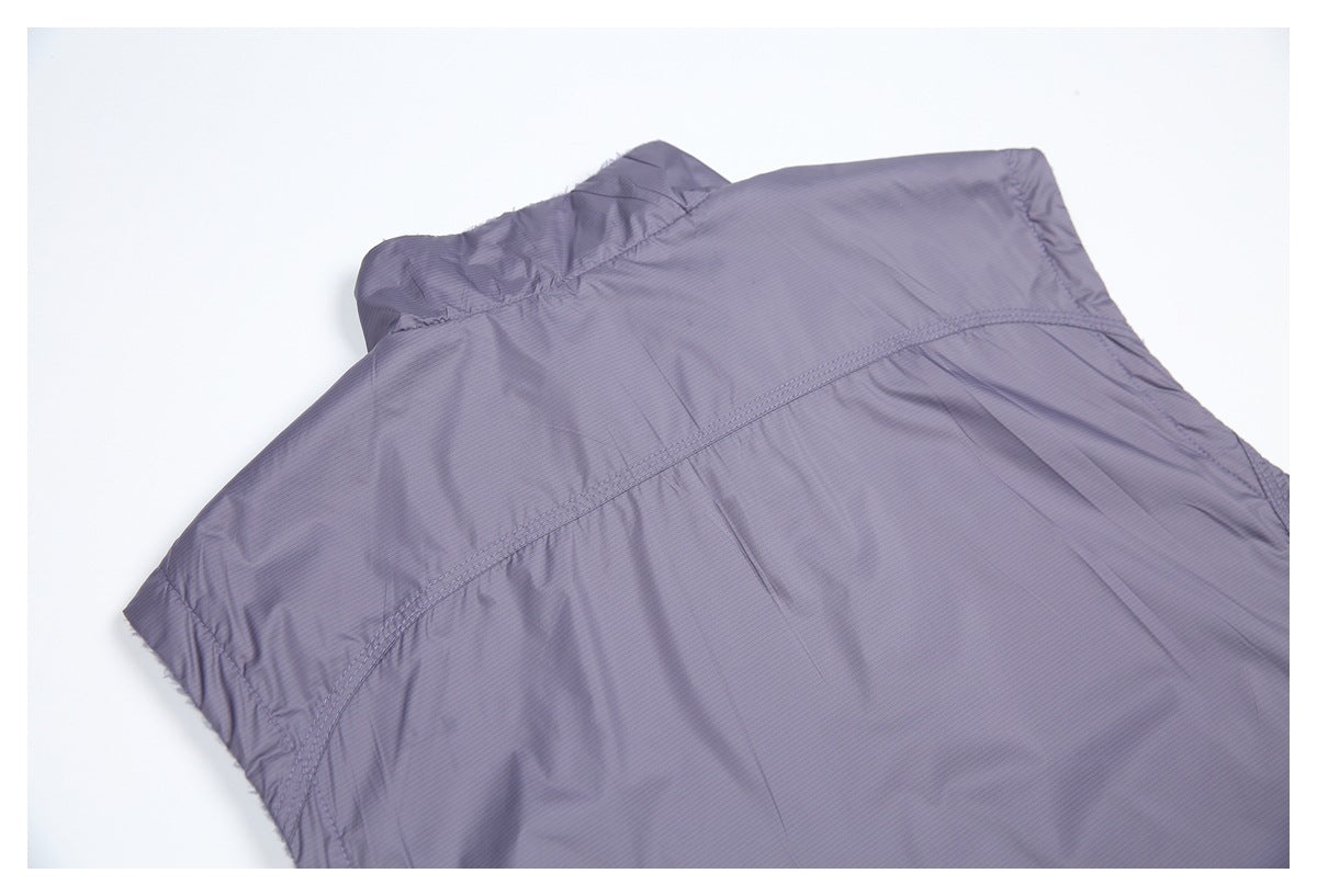 Flat view of the upper back of a grayish lavender jacket, showing the collar, shoulder seams, and curved panel stitching.