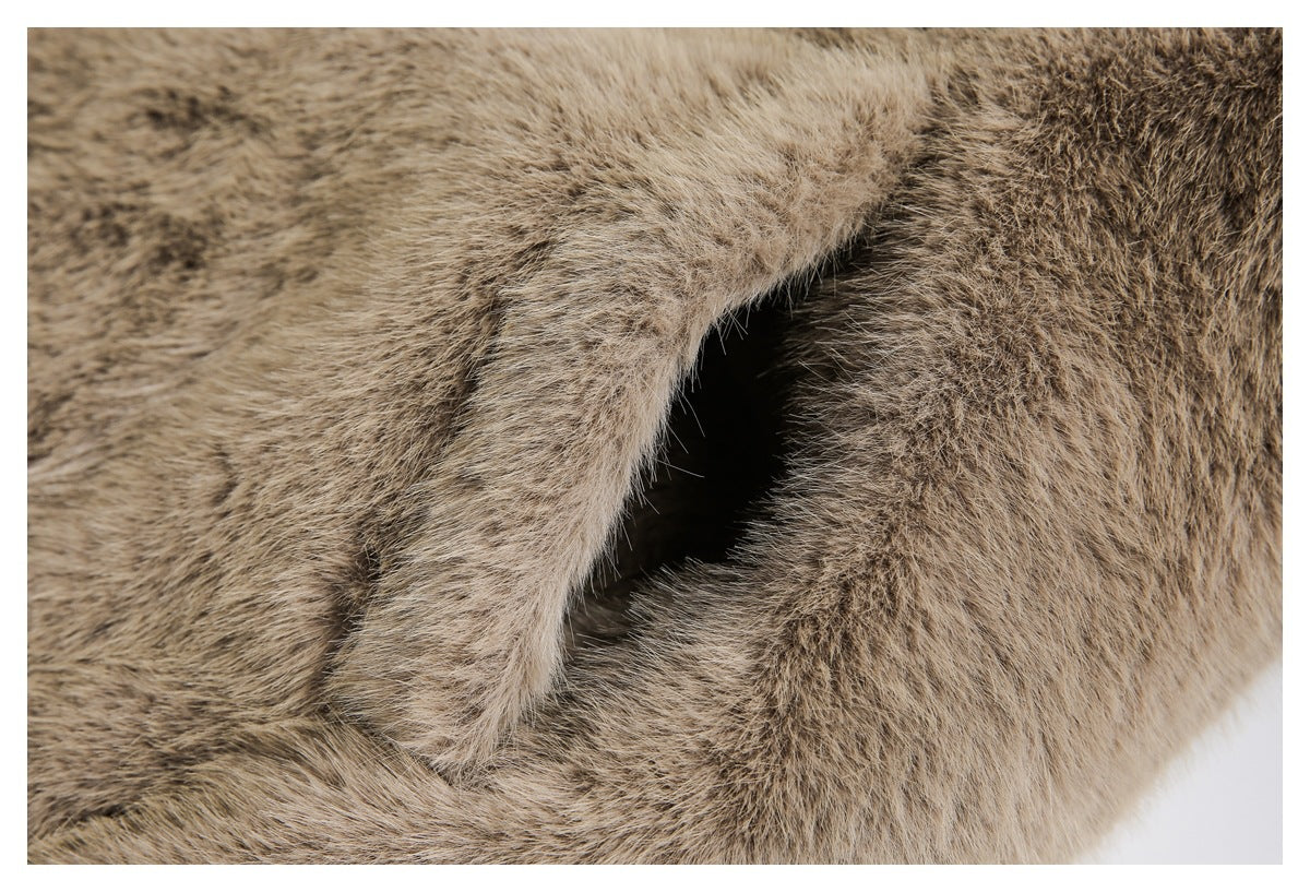 Close-up of a dark opening or pocket set into dense brown faux fur.